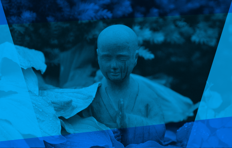 Buddha nestled inside green leaves